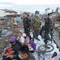 Soldiers and residents look at the devastation of the town from a military aid supplies distribution truck after the Super Typhoon Haiyan battered Tacloban, Philippines. The typhoon, one of the strongest storms in history, is believed to have killed tens of thousands, but aid workers were still trying to reach remote areas.
