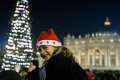 Carla Maria Valenzi, 6, wears a Christmas hat in St. Peter&#039;s Square after Pope Francis&#039; Christmas Eve Mass at the Vatican Dec. 24