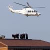 Clergy and Vatican workers wave from a rooftop as the helicopter carrying Pope Benedict XVI leaves the Vatican on its way to the papal summer residence at Castel Gandolfo, Italy, Feb. 28.