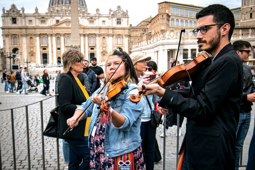 Métis fiddler Alex Kusturok, right, said it was an amazing experience to play in Rome for Pope Francis.