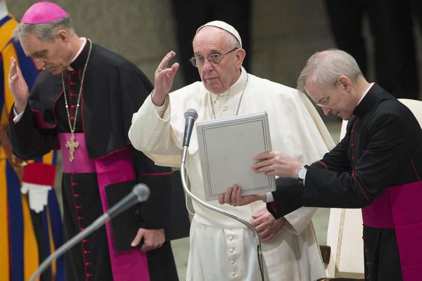Pope Francis gestures during his Dec. 28 weekly audience in Paul VI hall at the Vatican. 