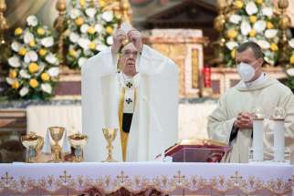 Pope Francis elevates the Eucharist as he celebrates Mass for Divine Mercy Sunday at the Church of the Holy Spirit near the Vatican on April 11. U.S. bishops are drafting a document on the Eucharist as part of a revival plan.