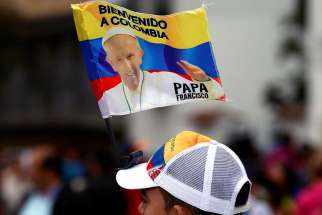 A man is seen with a Pope Francis flag in Bogota, Colombia, Sept. 3.