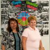  Roma Centre of Toronto settlement worker Gyongyi Hamori and Margit  Balogh in front of a poster documenting the history of attacks on Roma in Eastern Europe. 