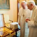 Pope Francis exchanges a gift with retired Pope Benedict XVI after arriving at the papal summer residence in Castel Gandolfo, Italy, March 23.