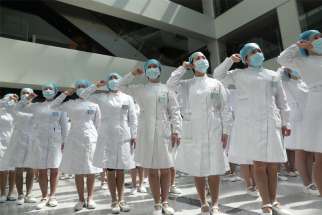 Nurses wearing face masks take part in an event held to mark International Nurses Day, at Wuhan Tongji Hospital in Wuhan, China, May 12, 2020, during the COVID-19 pandemic.