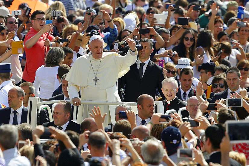Pope Francis waves as he arrives to lead his general audience in St. Peter&#039;s Square at the Vatican June 17. 