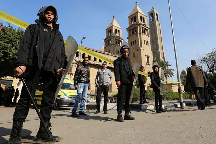 Members of the special police forces stand guard to secure the area around the Coptic Orthodox cathedral complex Dec. 11, 2016 after an explosion inside the complex in Cairo.