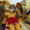 Julie Mauceri (left) leads high school students in a mock trauma resuscitation in the Allan Waters Family Simulation Centre.