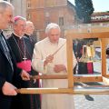 Pope Benedict XVI rings the International Eucharistic Congress Bell before his general audience at the Vatican March 14. At left are Father Kevin Doran, secretary general of the International Eucharistic Congress, and Archbishop Diarmuid Martin of Dublin , president of the congress. 