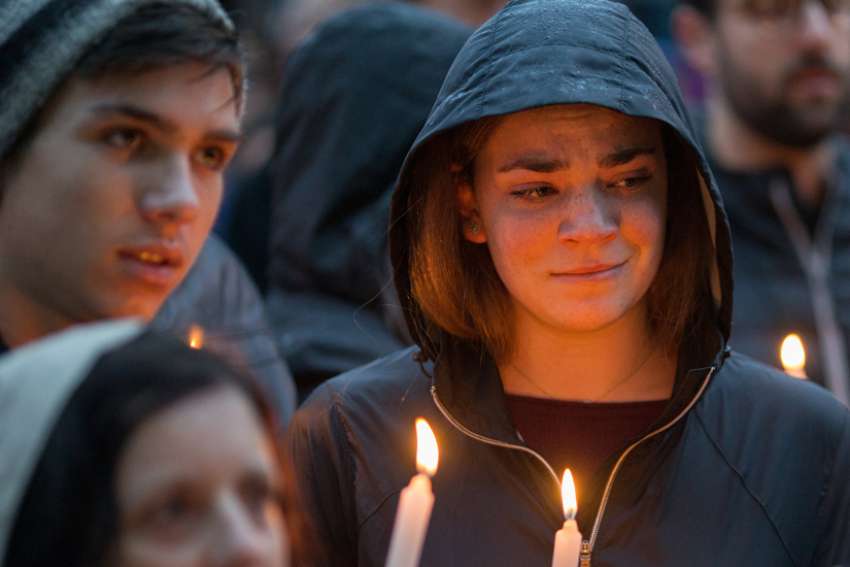 People mourn during a candlelight vigil Oct. 27, 2018, for victims of the shooting that killed eleven people at the Tree of Life Synagogue in Pittsburgh. In light of continued attacks on houses of worship and holy sites around the world, the U.S. Commission on International Religious Freedom held an Oct. 23, 2019, hearing at the Capitol to learn ways to deter such attacks.