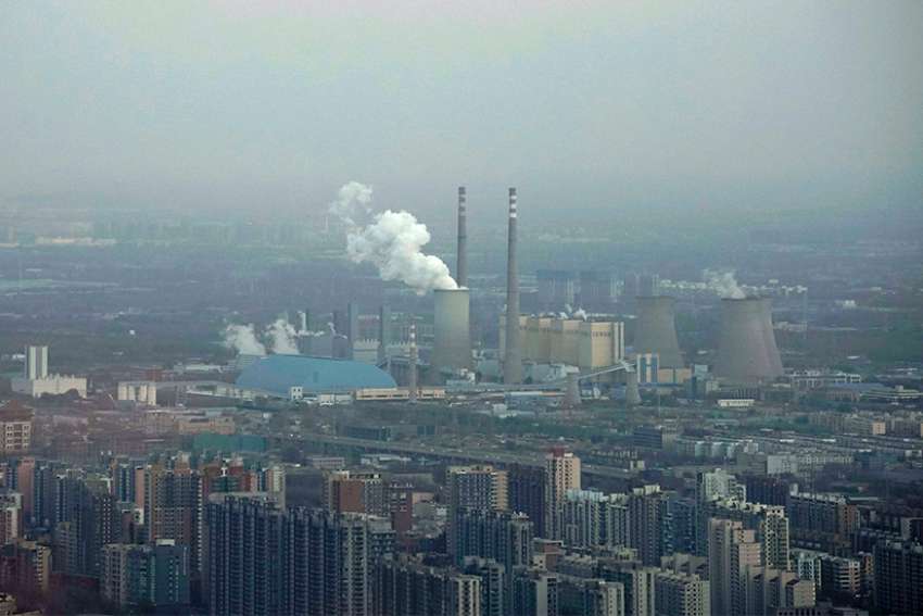  A thermal power plant is seen Nov. 21 near residential buildings in Beijing. As government delegations from across the globe prepare for a Dec. 2-14 U.N. conference on climate change, Catholic organizations are urging radical steps and pledging to make the church&#039;s voice heard.