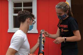 Student volunteers help prepare tiny homes for the homeless in Kitchener, Ont.