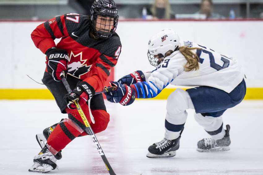 Emma Venusio skates through a Team USA defender as a member of Team Canada. The student at Toronto’s Bishop Allen Academy captained Team Canada to a bronze medal at the recent World U-18 championships in Switzerland.