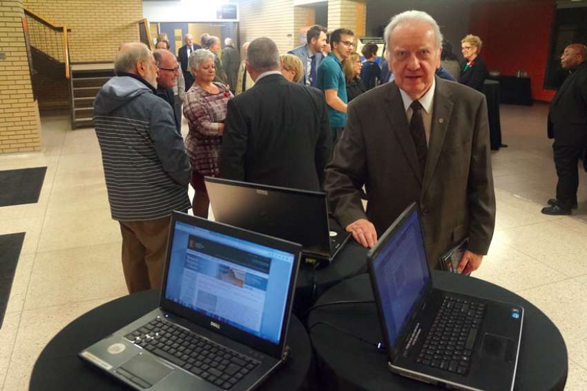 Fr. Pierre Hurtubise, OMI, with laptops showing the new Internet portal to inventories of tens of thousands of Vatican documents on Canada from 1622-1922. The Saint Paul University professor has been part of an international team that began the archive project in 1977. The website was launched Nov. 3.
