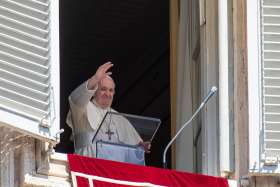 Pope Francis waves as he leads the Angelus from the window of his studio overlooking St. Peter&#039;s Square at the Vatican Aug. 16, 2020. The pope appealed for prayers for those who have lost their jobs because of the COVID-19 pandemic.