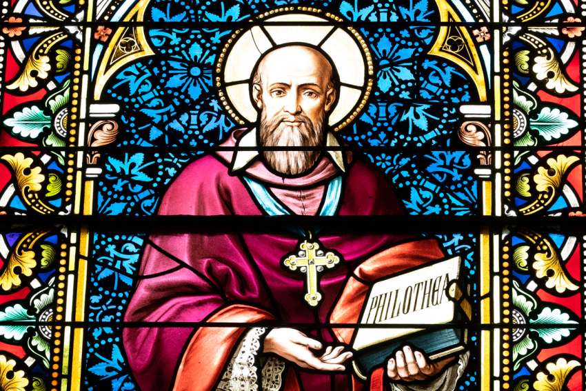 A likeness of St. Francis de Sales is seen in stained glass at Caldwell Chapel on the campus of The Catholic University of America in Washington in this May 25, 2021, file photo. Pope Francis in his message for World Communications Day said that the media and the field of communications need to exercise more kindness and share the truth with charity.