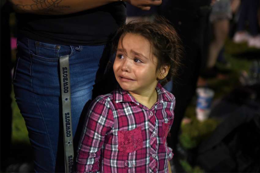 Serenity Lara cries during an Aug, 4, 2019, vigil, a day after a mass shooting at a Walmart store in El Paso, Texas. Pope Francis joined Catholic Church leaders expressing sorrow after back-to-back mass shootings in the United States left at least 31 dead and dozens injured in Texas and Ohio Aug. 3 and 4.