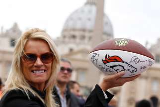 Linda Del Rio holds a football signed by members of the Denver Broncos, outside St. Peter&#039;s Square at the Vatican Oct. 20. Del Rio was in town to attend a Vatican sports meeting and present the football to Pope Francis.