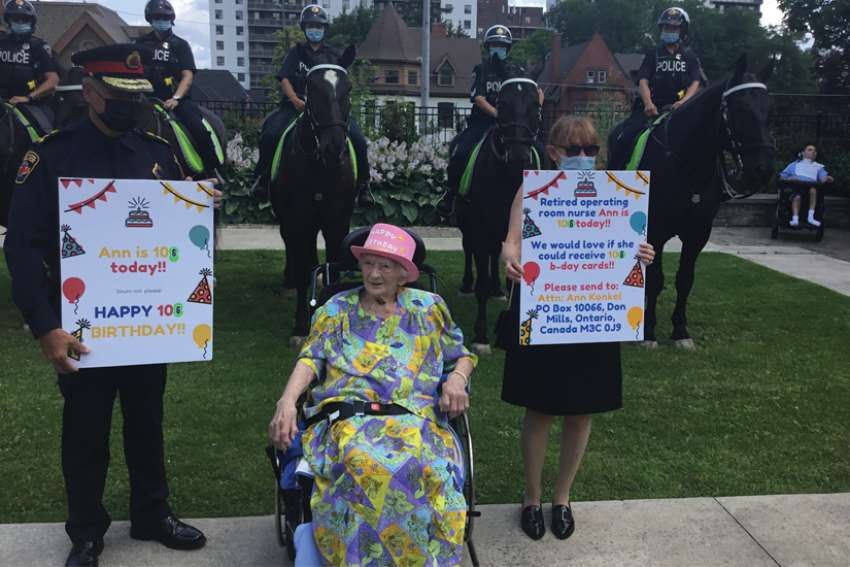 Hamilton Police Chief Frank Bergen, standing to the right of Ann Konkel, seated, and the service’s mounted unit helped Konkel celebrate her 106th birthday July 14.