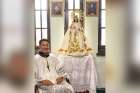 Marvin-Paul Fernandez with a statue of Mary at Assumption of the Blessed Virgin Mary Parish in Ottawa.