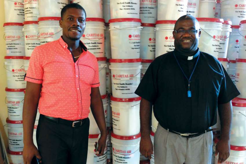 Caritas co-ordinators with hygiene kits for hurricane victims in Haiti.