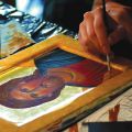 Precision brush strokes add vibrant colour to a portrait of Jesus at the Living Water College in Derwent, Alta.