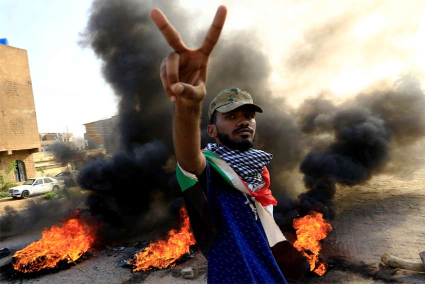 A Sudanese protester gestures during a demonstration in Khartoum July 27, 2019. Bishop Yunan Andali of El Obeid said the country has become too fragile, after months protests in which demonstrators have been pushing for a civilian government.