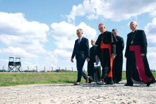 Cardinal Michael Czerny, prefect of the Dicastery for Promoting Integral Human Development, centre, and Archbishop Marek Jedraszewski of Krakow, Poland, attend ceremonies commemorating the 80th anniversary of the martyrdom of St. Teresa Benedicta of the Cross, also known as St. Edith Stein, at the Auschwitz Nazi concentration camp in Oswiecim, Poland, Aug. 9. Czerny’s grandmother was among those who died at the camp.