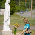 Michelle Sherlock of August, Ga., prays in front of a statue of Blessed Kateri Tekakwitha on her July 14 feast day in Fonda, N.Y. Blessed Kateri will become the first member of a North American tribe to be declared a saint when she is canonized Oct. 21. The Fonda shrine dedicated to her is located near the 17th-century Mohawk settlement where she was raised and baptised.