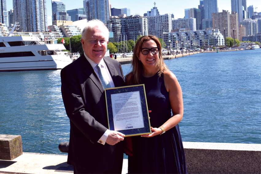 Robert G. Kearns, left, chair and founder of the Canada Ireland Foundation, is presented with a declaration of June 6, 2022, as the 175th anniversary of the arrival of Irish migrants fleeing the famine by Toronto Deputy Mayor Ana Bailão.