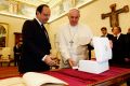 Pope Francis exchanges gifts with French President Francois Hollande during a private audience at the Vatican Jan. 24.