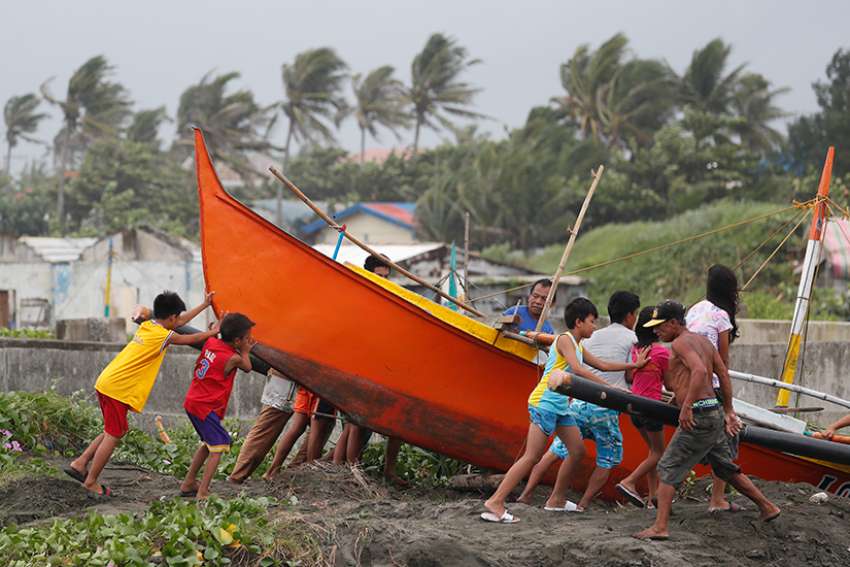  Villagers in Aparri, Philippines, secure a boat Sept. 14 in preparation for super Typhoon Mangkhut. The storm threatens more than 4 million people in the north of the country. 