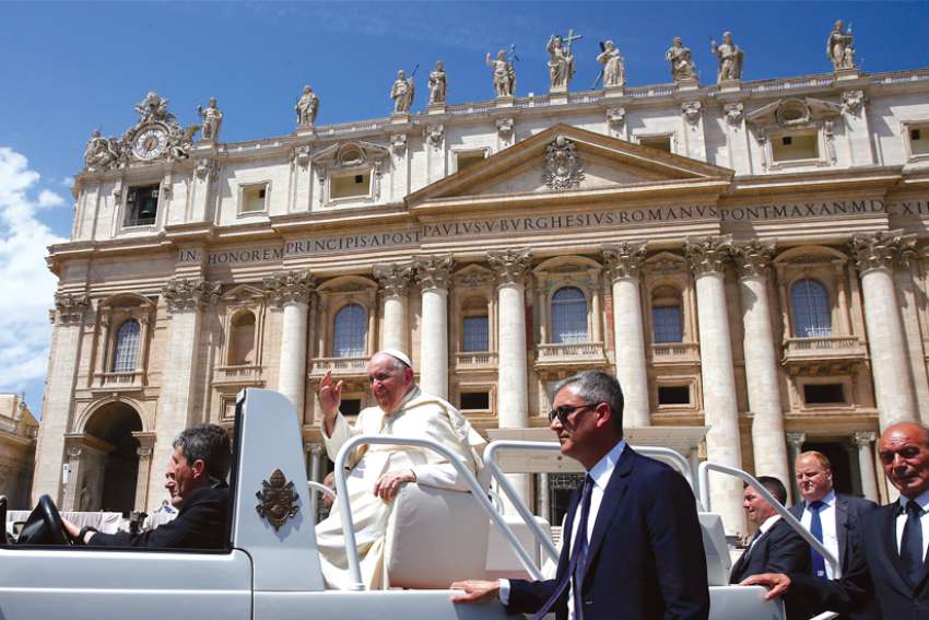 Pope Francis rides in the popemobile as he leaves his general audience in St. Peter’s Square at the Vatican May 25.