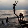 Boys from Bujumbura, Burundi, take a dip at sunset in Lake Tanganyika. It’s but one of Fr. Don Doll, S.J.’s photographs from his 50-year career as a photojournalist.