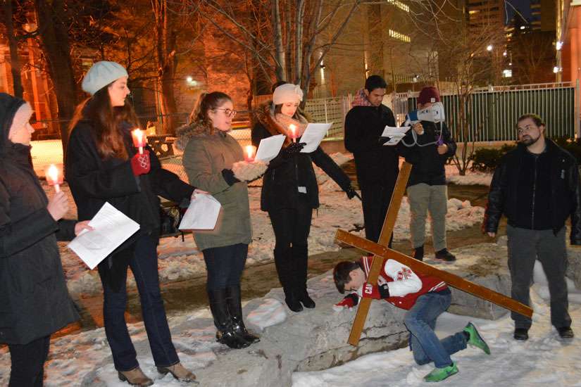 Students from three downtown university chaplaincies processed and re-enacted the Stations of the Cross on a cold winter day March 4.