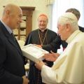 Pope Benedict XVI holds a copy of his book Jesus of Nazareth: The Infancy Narratives as he talks with publisher Paolo Mieli, left, and Cardinal Gipanfranco Ravasi, president of the Pontifical Council for Culture, at the Vatican Nov. 20.