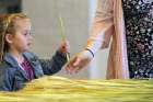 A girl receives a palm frond during Palm Sunday Mass.
