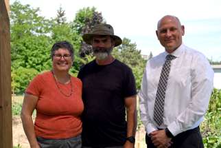 Linda Busuttil and Ralf Mesenbrink pictured in co-op garden with Wellington Catholic DSB (WCDSB) director of education Michael Glazier.