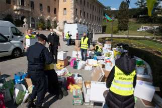 People sort donations from Vatican employees for Ukraine outside the Governatorato, a building housing the Vatican&#039;s governing offices, at the Vatican March 7, 2022.