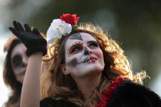 A woman dressed as &quot;Catrina&quot; takes part in a parade Oct. 27, 2019, ahead of Day of the Dead in Monterrey, Mexico. Day of the Dead is a Mexican custom traditionally observed Nov. 1 and 2 to remember family and friends who have died.