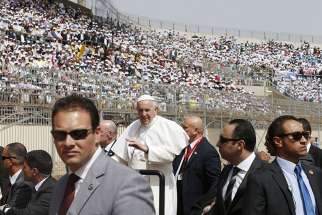 Pope Francis greets the crowd as he arrives to celebrate Mass at the Air Defense Stadium in Cairo April 29. 