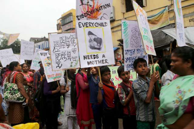 Sex workers and their children take part in an Aug. 14 demonstration seeking better rights and a halt to girl trafficking in the red-light area of Kolkata, India. Human trafficking destroys the lives of millions of children, women and men each year, ma king it a real threat to peace, the Vatican said as it announced Pope Francis&#039; 2015 World Peace Day message would focus on the phenomenon.