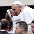 A girl hugs Pope Francis in St. Peter&#039;s Square at the Vatican May 15.
