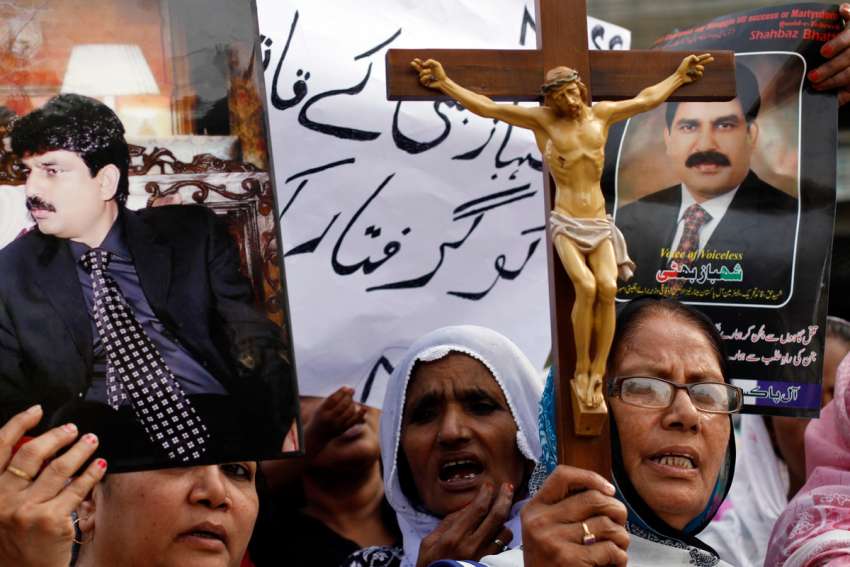 Christian women hold pictures of Shahbaz Bhatti, the slain Pakistani minister of minorities, as they demand a sentence for his killers during a protest in Karachi, Pakistan, April 6, 2011.