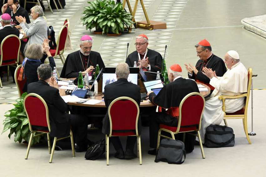 Pope Francis and leaders of the assembly of the Synod of Bishops applaud at the conclusion of the gathering&#039;s last working session Oct. 28, 2023, in the Paul VI Hall at the Vatican.