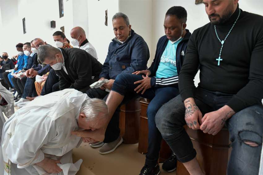 Pope Francis kisses the foot of an inmate after washing it during the Holy Thursday Mass of the Lord&#039;s Supper at a prison in Civitavecchia, Italy, April 14, 2022.