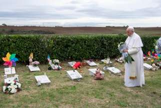 Pope Francis visits graves of children before celebrating Mass marking the feast of All Souls at Laurentino Cemetery in Rome Nov. 2, 2018.