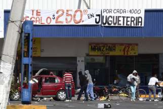 People are seen looting stores in Actopan, Mexico, during a Jan. 4 protest against increasing gas prices. Mexican bishops are calling for calm after an increasing number of protests over high gas prices.