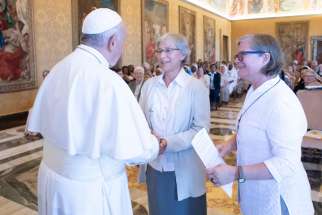 Pope Francis talks with women religious during a Sept. 25, 2019, meeting at the Vatican with delegates of Talitha Kum. Pictured with the pope are Claretian Missionary Sister Jolanda Kafka, president of the International Union of Superiors General, and Comboni Sister Gabriella Bottani, Talitha Kum&#039;s international coordinator.